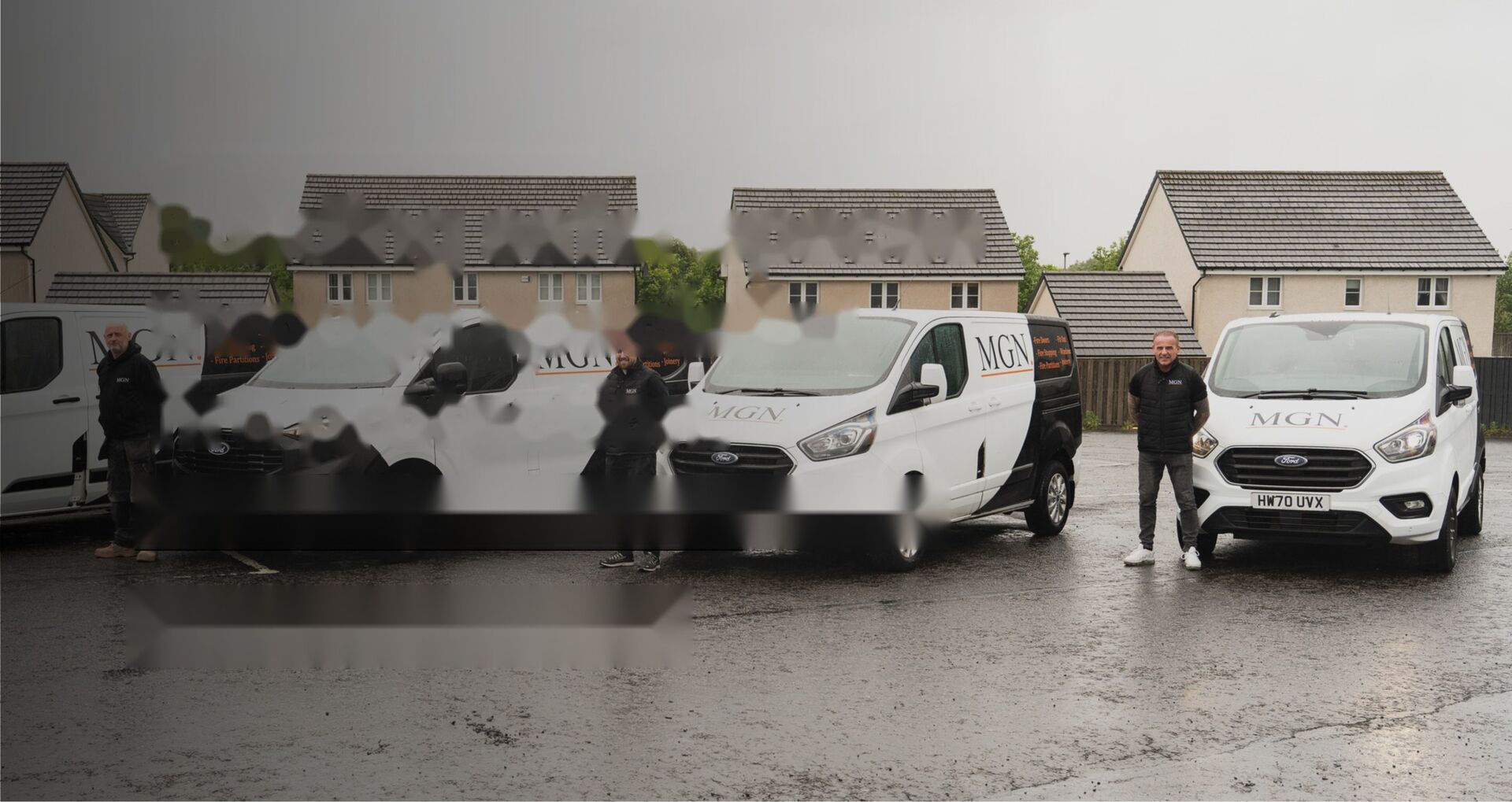 MGN Group operatives with liveried MGN vans outside a residential development